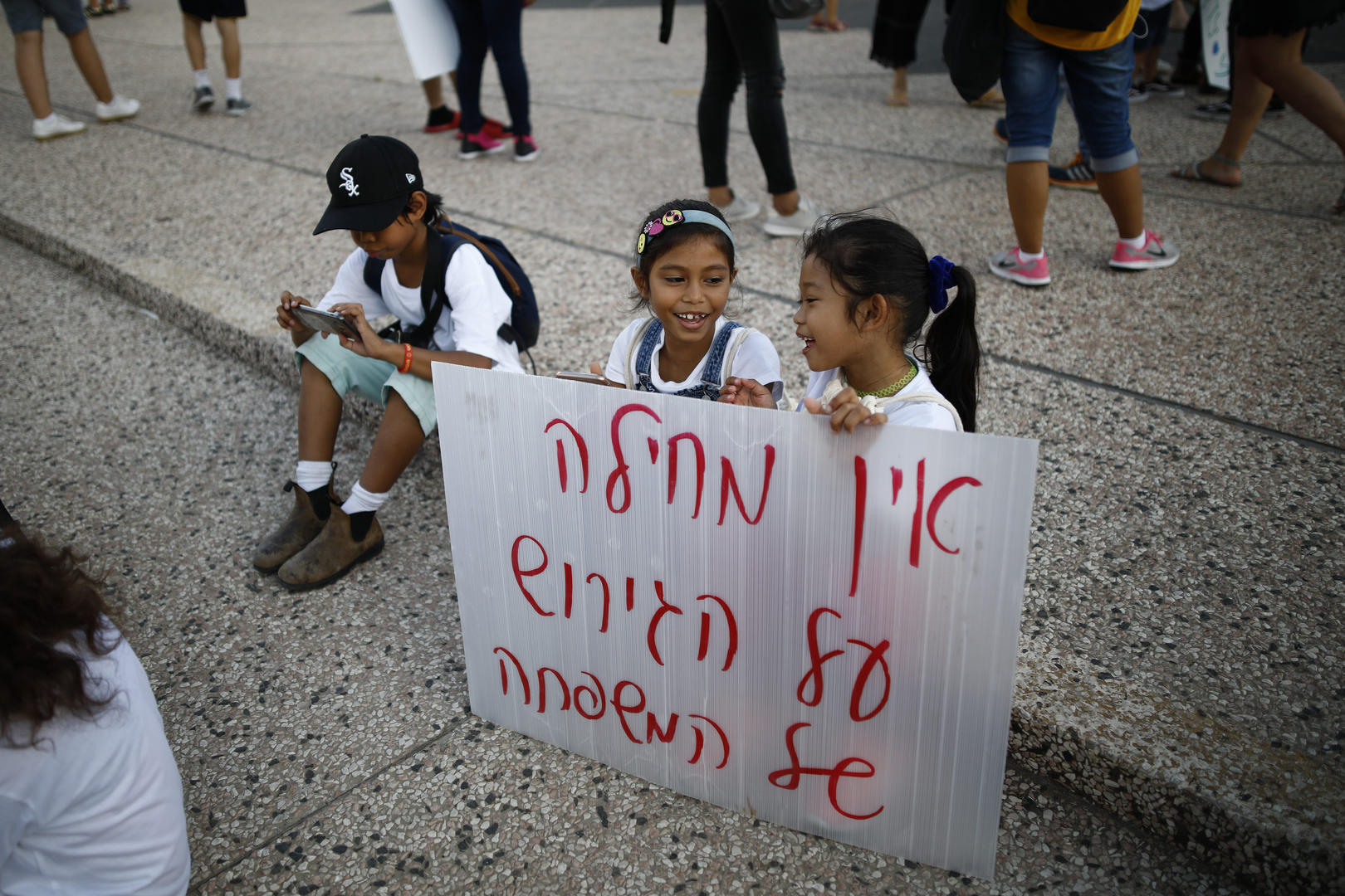 Children hold a sign at a protest.