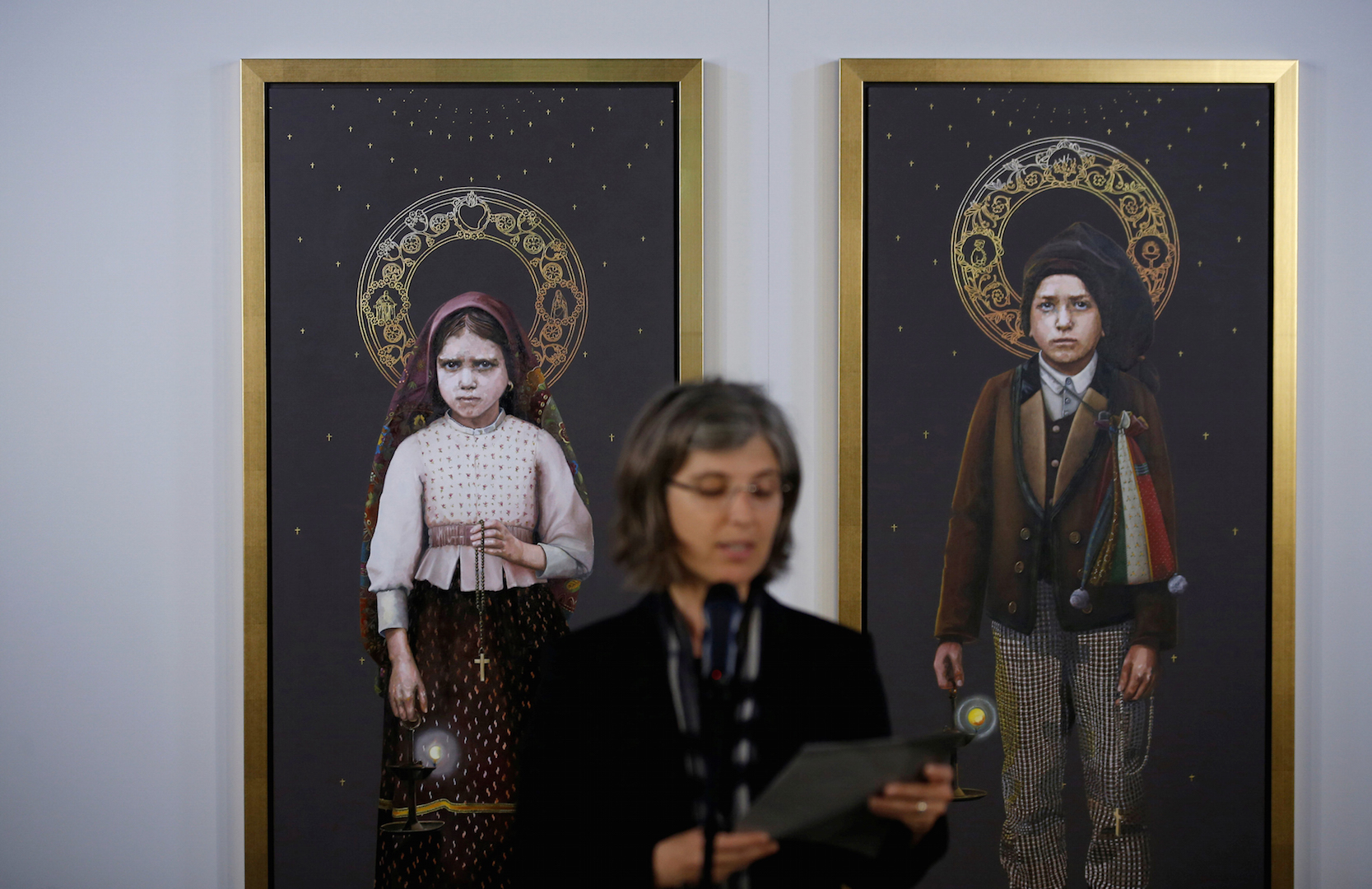 Two paintings of Blessed Jacinta Marto and Blessed Francisco Marto are presented during a May 8 news conference in Fatima, Portugal (CNS photo/Rafael Marchante, Reuters).