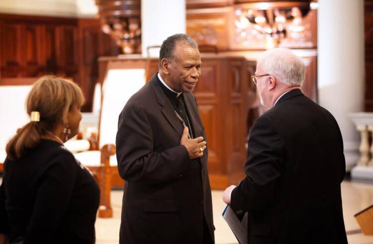 Bishop Edward K. Braxton of Belleville, Ill., greets the Rev. Timothy George, dean of Samford University's Beeson Divinity School. (CNS photo/Mary D. Dillard, One Voice)