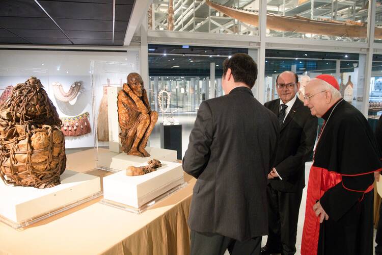 Peruvian Foreign Minister César Landa Arroyo, center, and Cardinal Fernando Vérgez Alzaga, president of the Pontifical Commission for Vatican City State, look at the mummies that will be returned to Peru.
