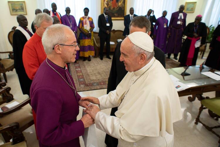 Pope Francis greets Anglican Archbishop Justin Welby of Canterbury.