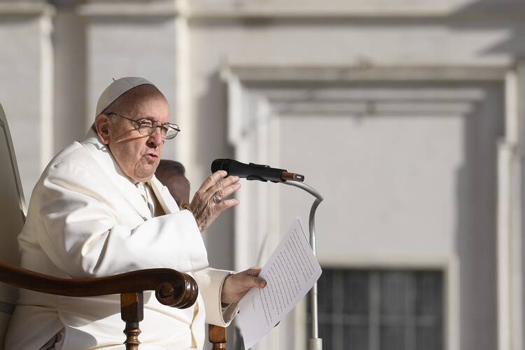 pope francis speaks into a microphone