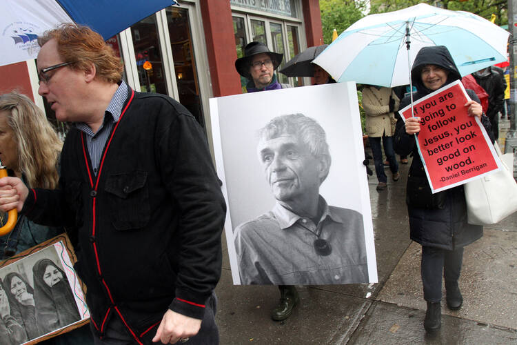 Mourners participate in a peace march May 6 prior to the funeral Mass of Jesuit Father Daniel Berrigan in New York City, May 6, 2016 (CNS photo/Gregory A. Shemitz).