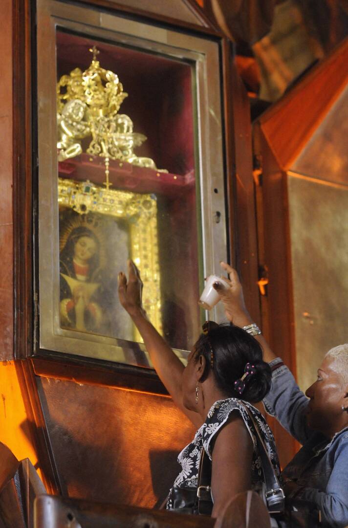 Women pray in front the image Our Lady of Altagracia. Thousands make a pilgrimage each year to the basilica to commemorate the Dominican Republic's patron saint. (CNS photo/Ricardo Rojas, Reuters)