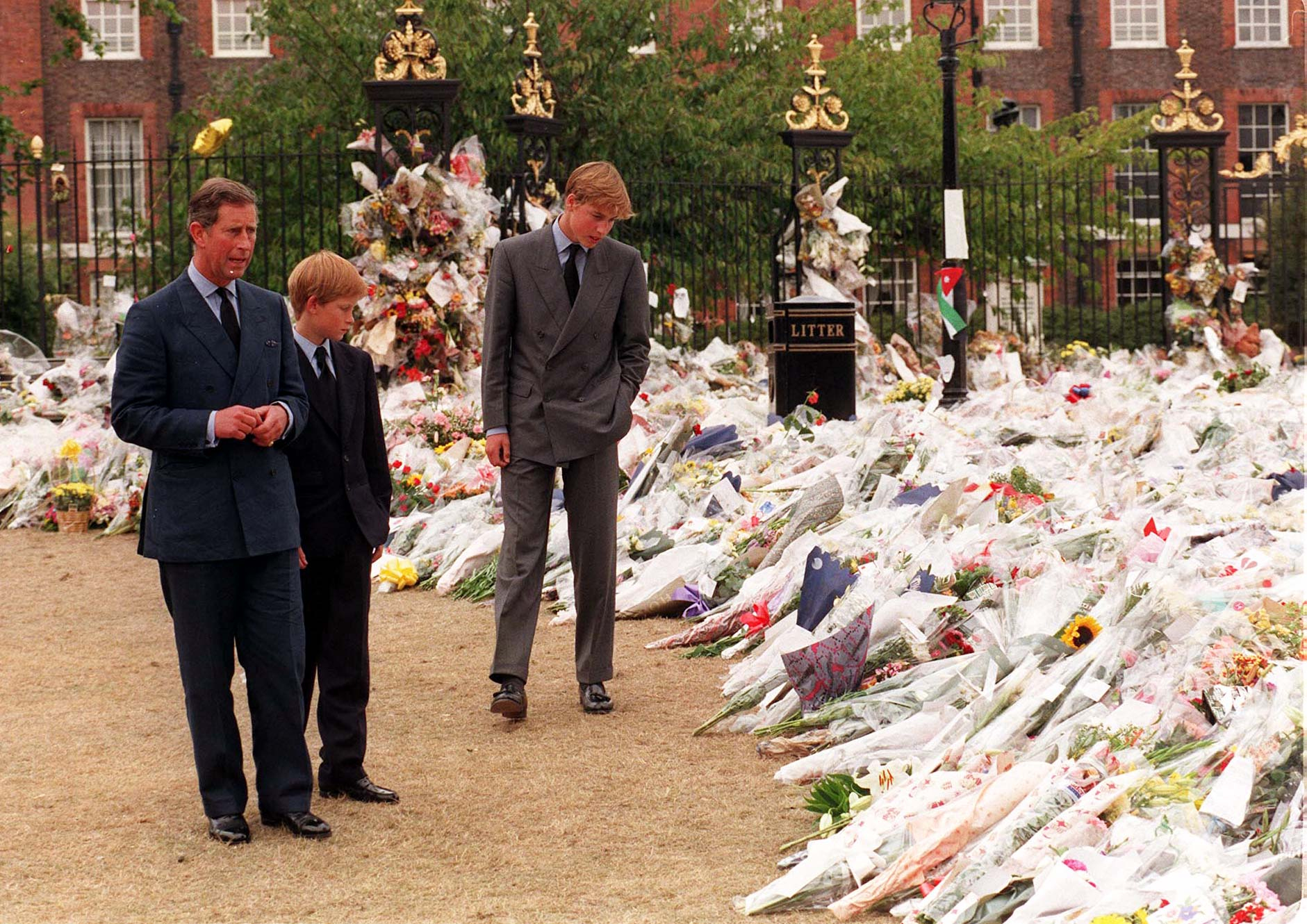 File photo dated 5/9/1997 of the Prince of Wales and his sons Prince William (right) and Prince Harry, view the sea of floral tributes to Diana, Princess of Wales, at Kensington Palace. The Princes on Wednesday viewed tributes attached to the Golden Gates of the Palace in London ahead of the 20th anniversary of their mother's death. Issue date: Friday September 5, 1997.