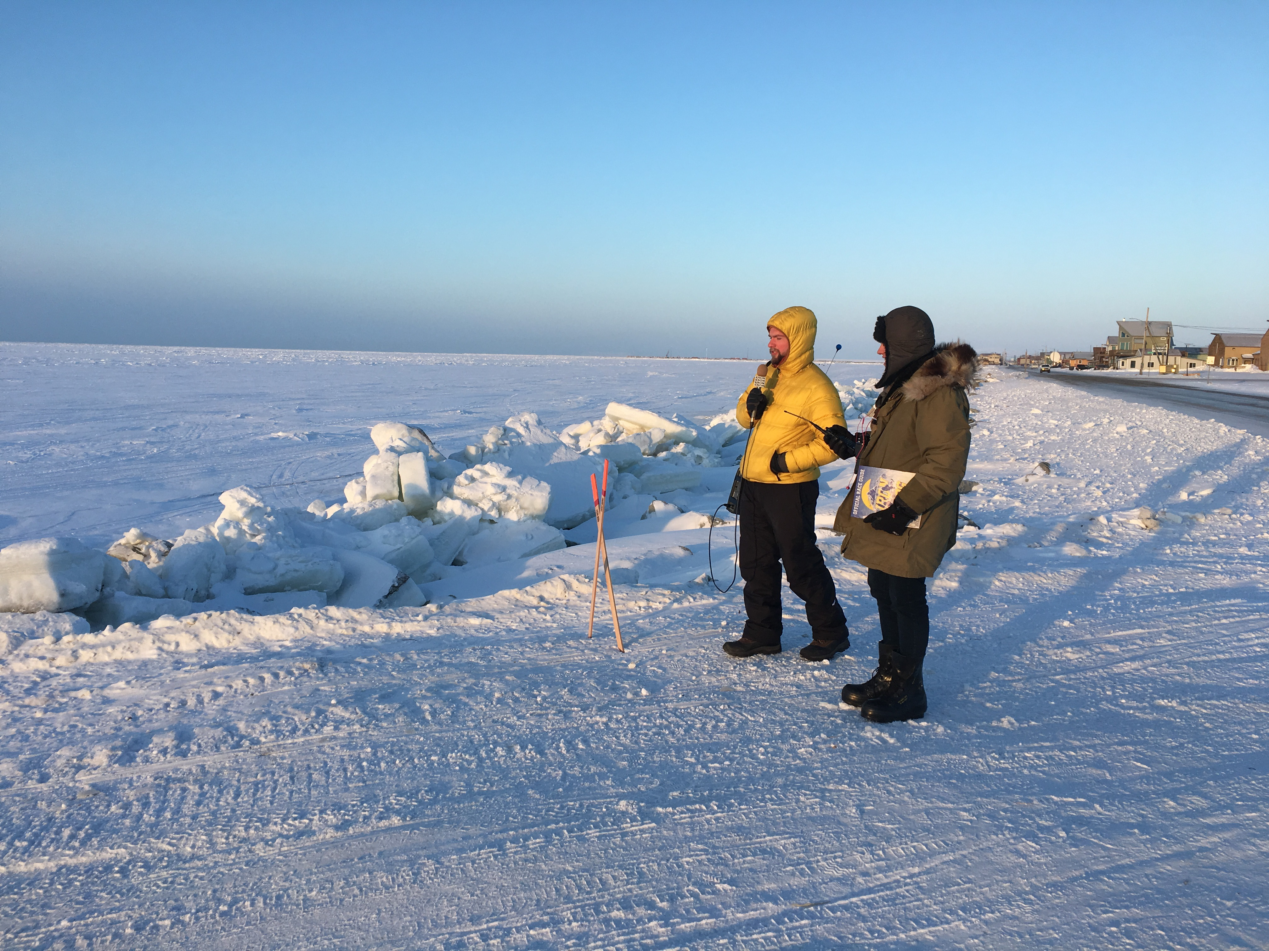 Davis Hovey and fellow reporter Tyler Stup await the arrival of the Iron Dog Snowmachine racers on the frozen Bering Sea.