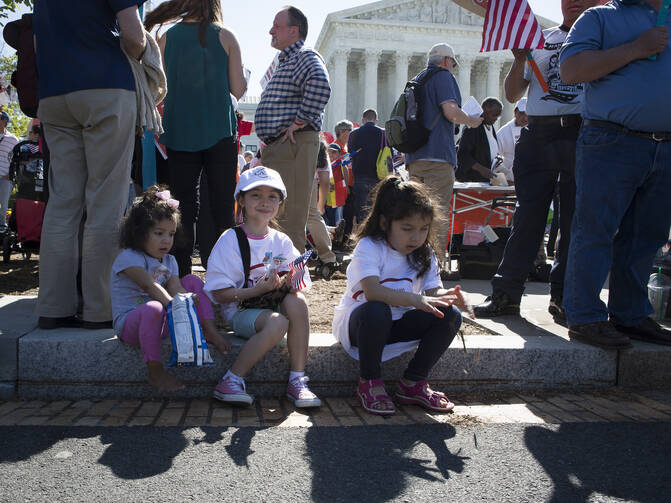 An immigration rally outside the U.S. Supreme Court in Washington in April. The U.S. bishops' migration committee chair in a statement on July 18 urged President Donald Trump to "ensure permanent protection" for youth under the Deferred Action for Childhood Arrivals program, or DACA. (CNS photo/Tyler Orsburn)