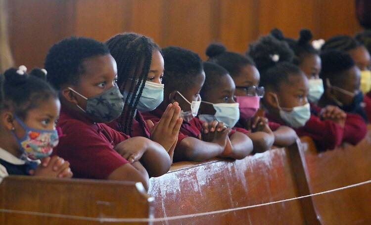 Students of Drexel Neumann Academy pray during Mass at St. Katharine Drexel Church in Chester, Pa., on May 24, 2021. (CNS photo/Sarah Webb, CatholicPhilly.com)