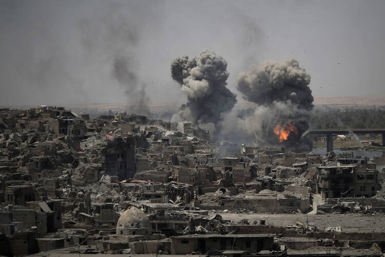 Airstrikes target Islamic State positions on the edge of the Old City on July 11 a day after Iraq's prime minister declared "total victory" in Mosul, Iraq. (AP Photo/Felipe Dana)