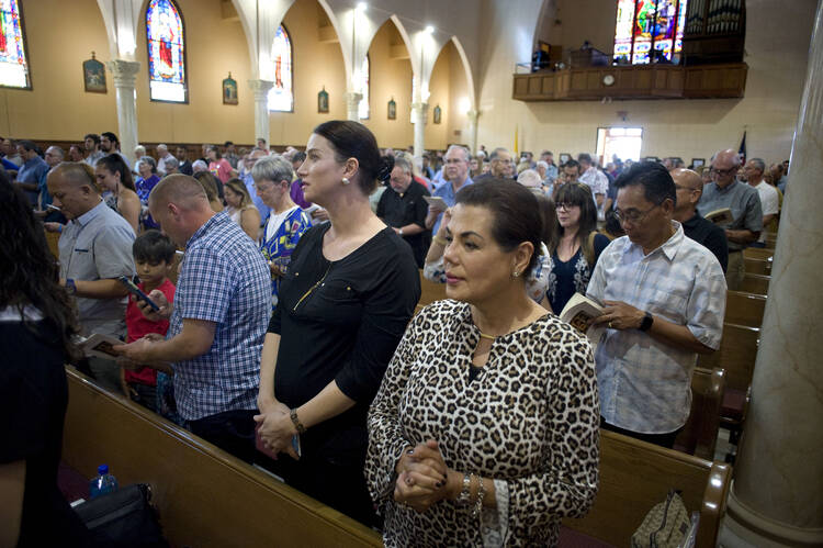 People pray during Mass Oct. 7 at St. John the Evangelist Church in San Diego (CNS photo/David Maung).