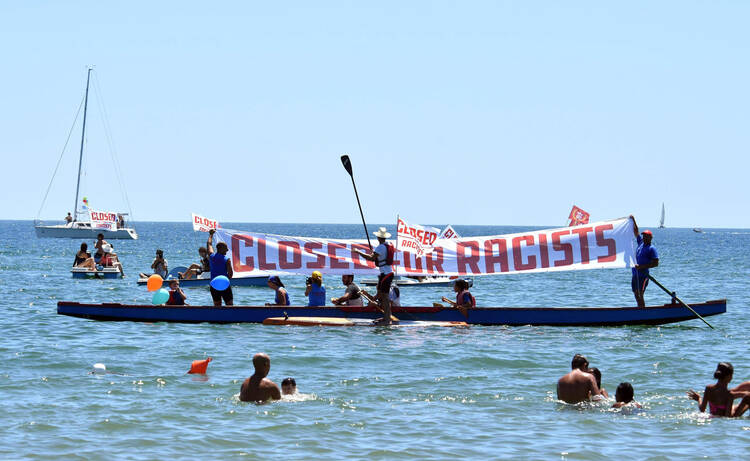 People join a demonstration titled, "City Flotilla, at Sea Against Racism," to protest against the scheduled arrival of the C Star, a ship that an anti-immigrant group has chartered to try and halt migrant arrivals to Europe from Africa and elsewhere, in Catania, Sicily Island, Italy, on July 29. (Orietta Scardino/ANSA via AP)
