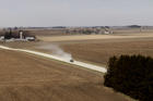 A truck travels along a dirt road near a grain farm in Hesper Township, Iowa. The 2018 farm bill was defeated on the floor of the House May 18. It could back for a second vote in late June, but Catholic and other rural life advocates see a need for improvements in the measure before then. (CNS photo/Bob Roller)